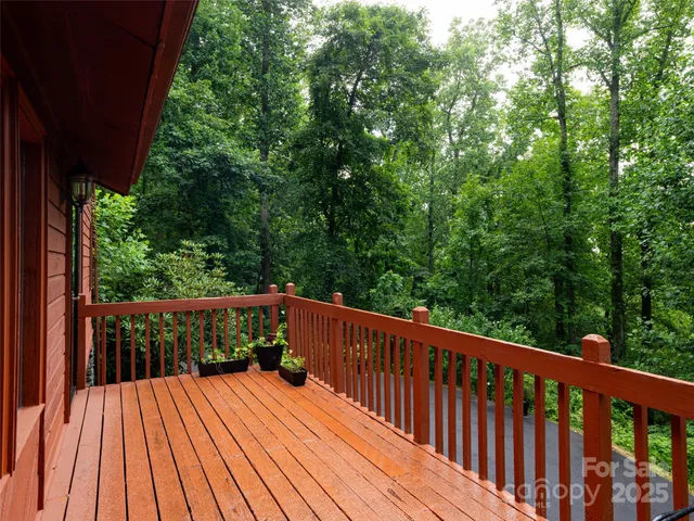 a balcony with wooden floor and outdoor space