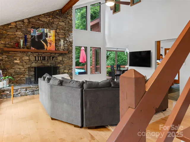 a living room with furniture a fireplace and a flat screen tv