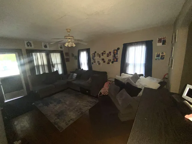 a living room with furniture and a chandelier