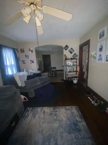 a living room with furniture and a chandelier