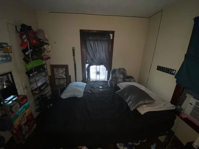 a bed sitting in a bedroom next to a window