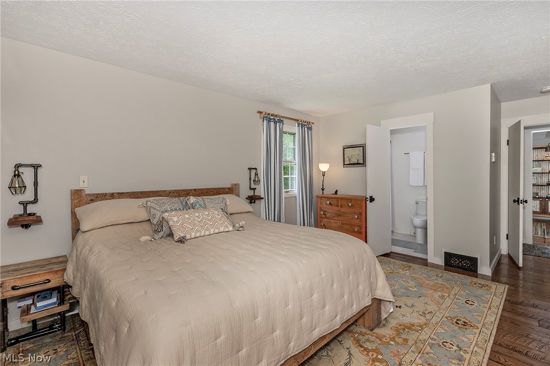 11292 Butternut Road Chardon, OH 44024 - Photo 24 of 49 Bedroom featuring wood-finish flooring, light gray wall paint, and a window with striped drapes