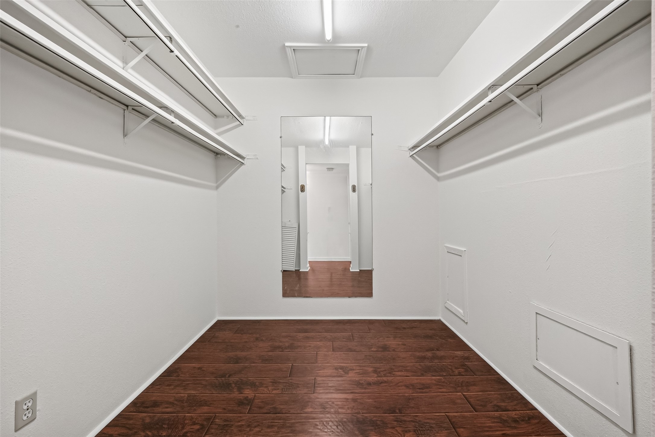 6401 Deihl Road, Unit 902 Houston, TX 77092 - Photo 18 of 35 Spacious walk-in closet offering ample storage with laminated floors and modern lighting.