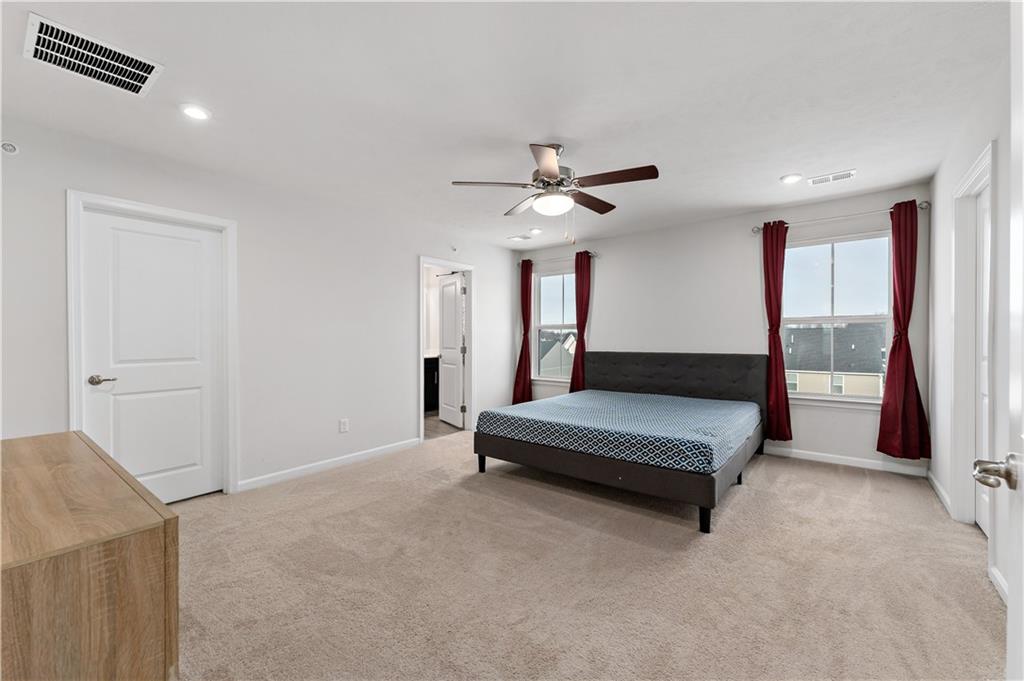 5103 Spruce Road Gibsonia, PA 15044 - Photo 14 of 50 a spacious bedroom with a large bed and a chandelier