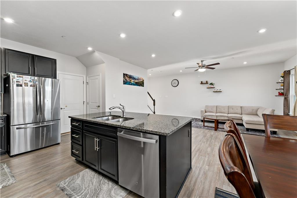 5103 Spruce Road Gibsonia, PA 15044 - Photo 7 of 50 a kitchen with stainless steel appliances granite countertop a sink a stove and a refrigerator