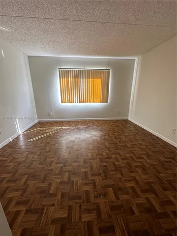a view of an empty room with windows