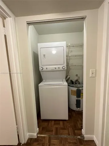 a utility room with closet dryer and washer