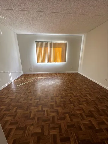 a view of an empty room with windows