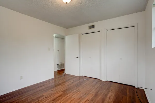 a view of an empty room and wooden floor