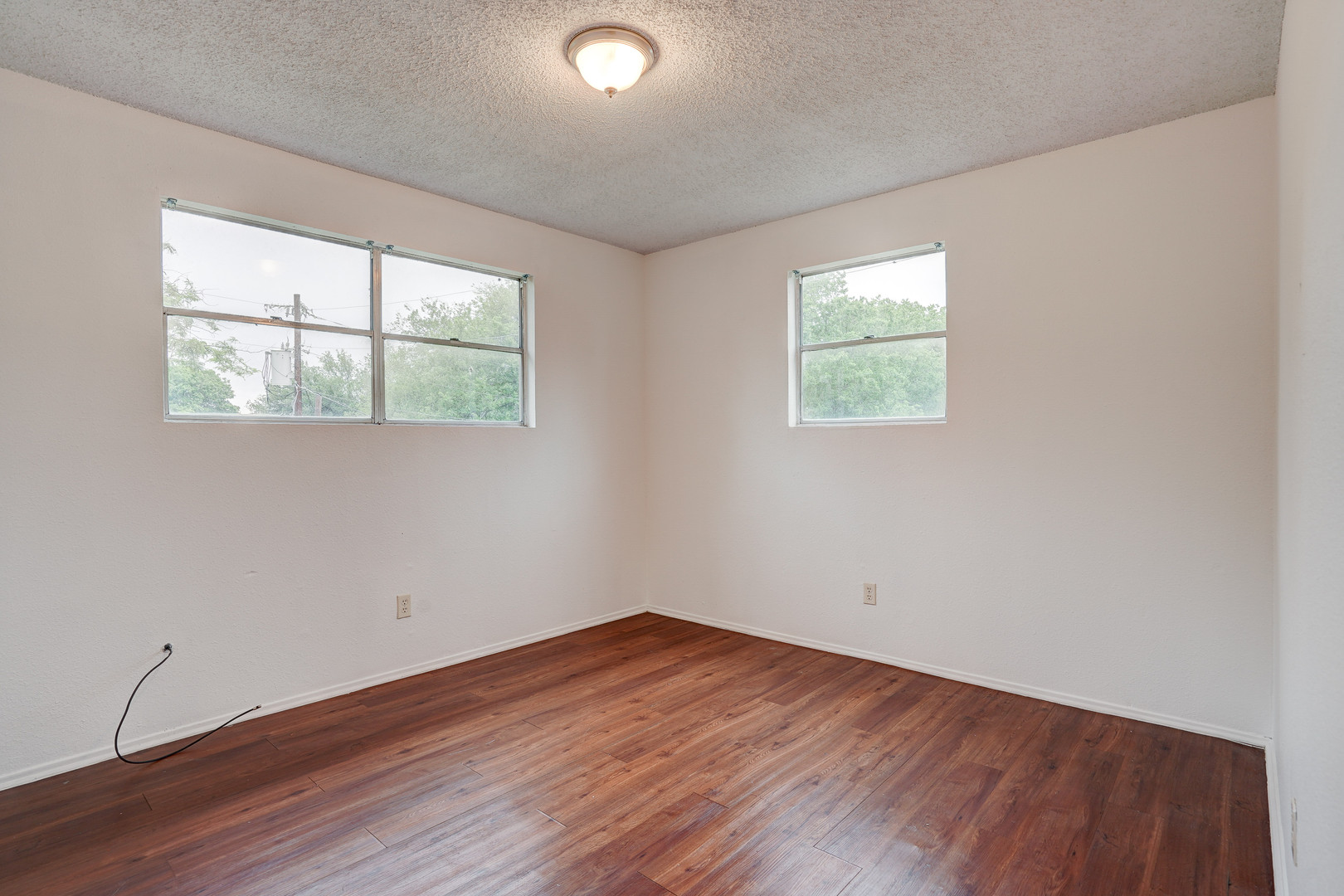 748 Old Martindale Road San Marcos, TX 78666 - Photo 15 of 18 an empty room with wooden floor and windows