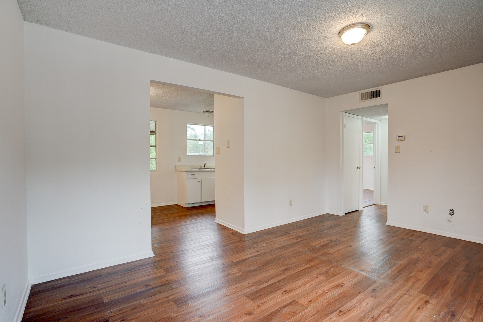 748 Old Martindale Road San Marcos, TX 78666 - Photo 5 of 18 wooden floor in an empty room with a window