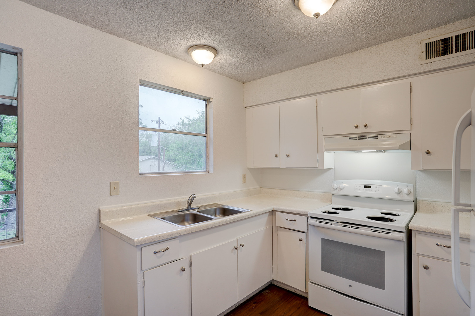 748 Old Martindale Road San Marcos, TX 78666 - Photo 6 of 18 a kitchen with granite countertop white cabinets and white appliances