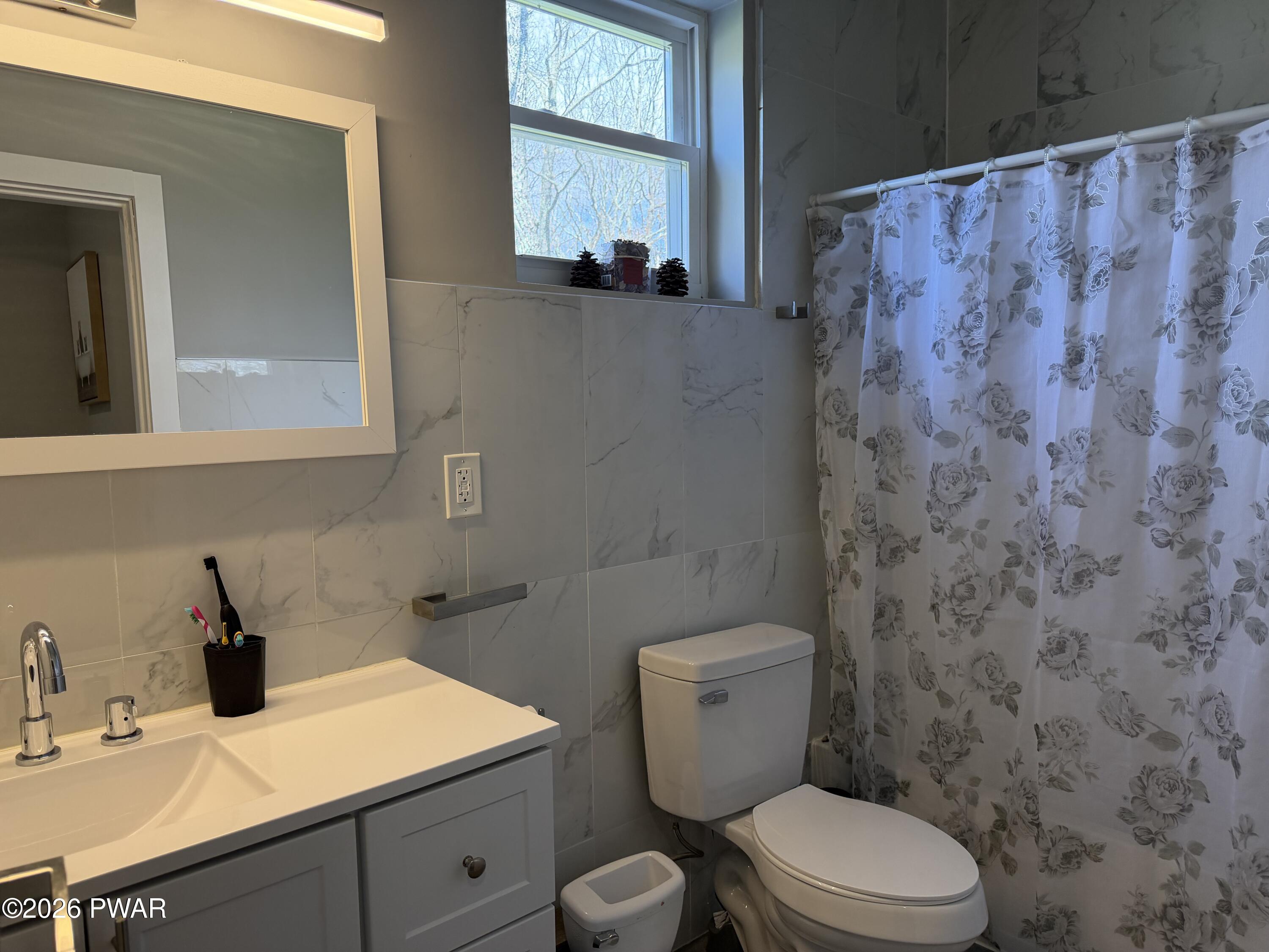 801 Maple Ridge Court Hawley, PA 18428 - Photo 40 of 55 a bathroom with a toilet sink and mirror