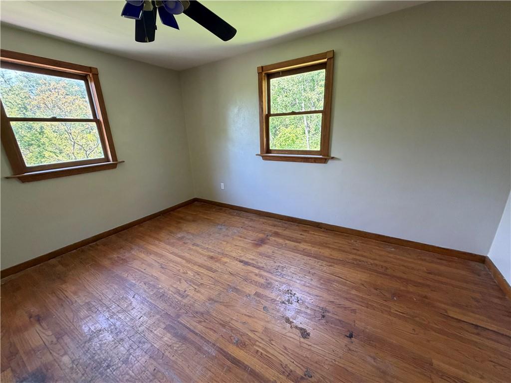 3079 Mt Troy Road Pittsburgh, PA 15212 - Photo 14 of 30 an empty room with windows and ceiling fan