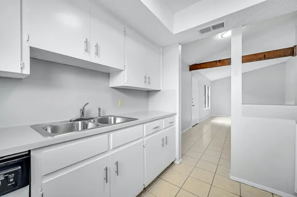 a kitchen with a stove and cabinets