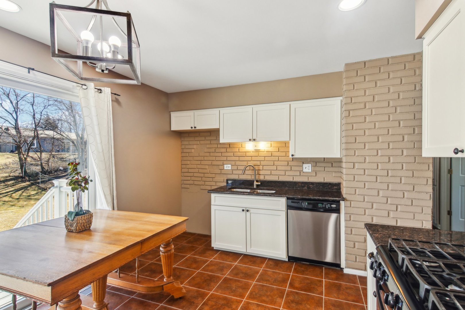 316 Bedford Road Bolingbrook, IL 60440 - Photo 12 of 38 a kitchen with stainless steel appliances granite countertop a sink stove and refrigerator
