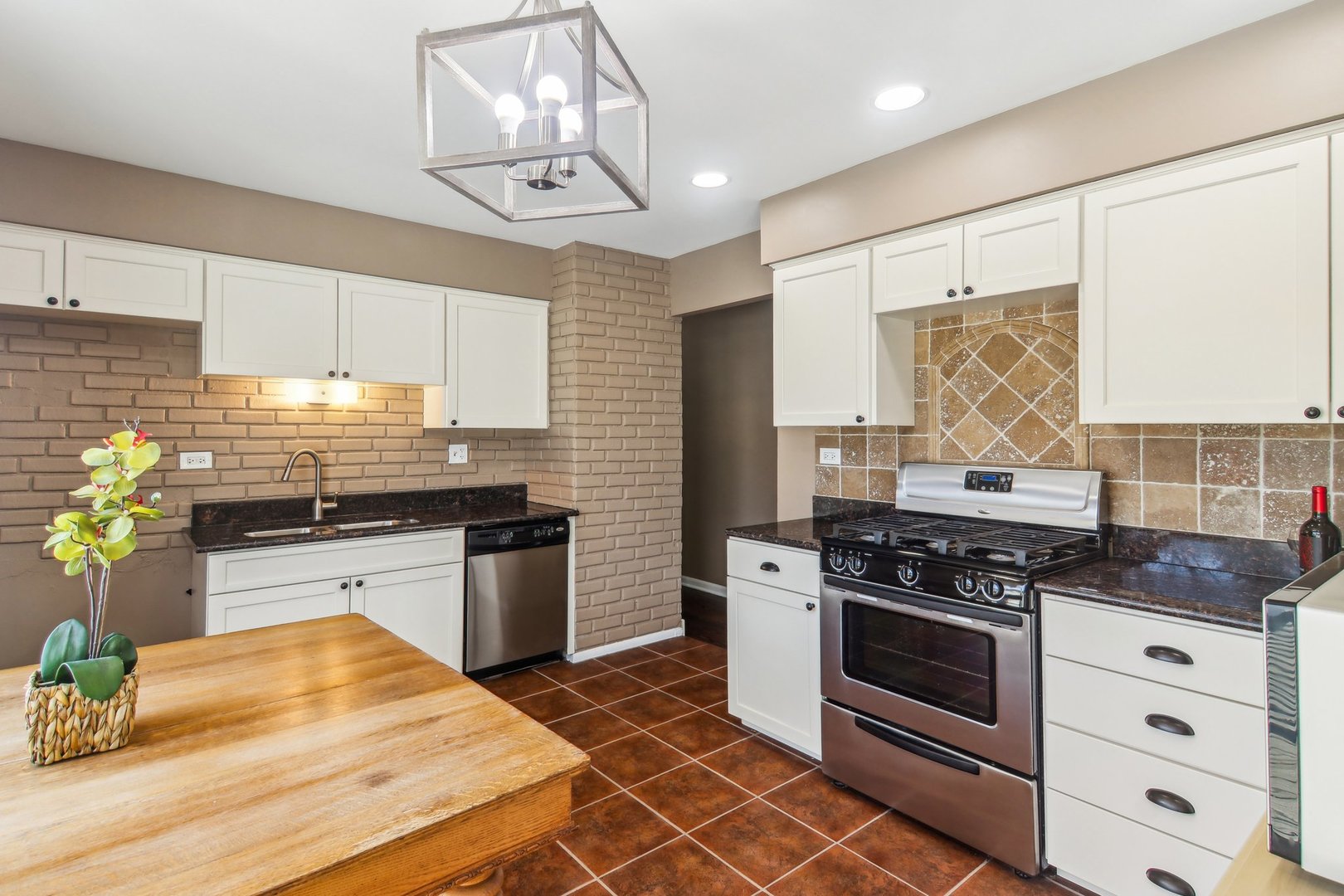 316 Bedford Road Bolingbrook, IL 60440 - Photo 13 of 38 a kitchen with stainless steel appliances a stove a sink and cabinets
