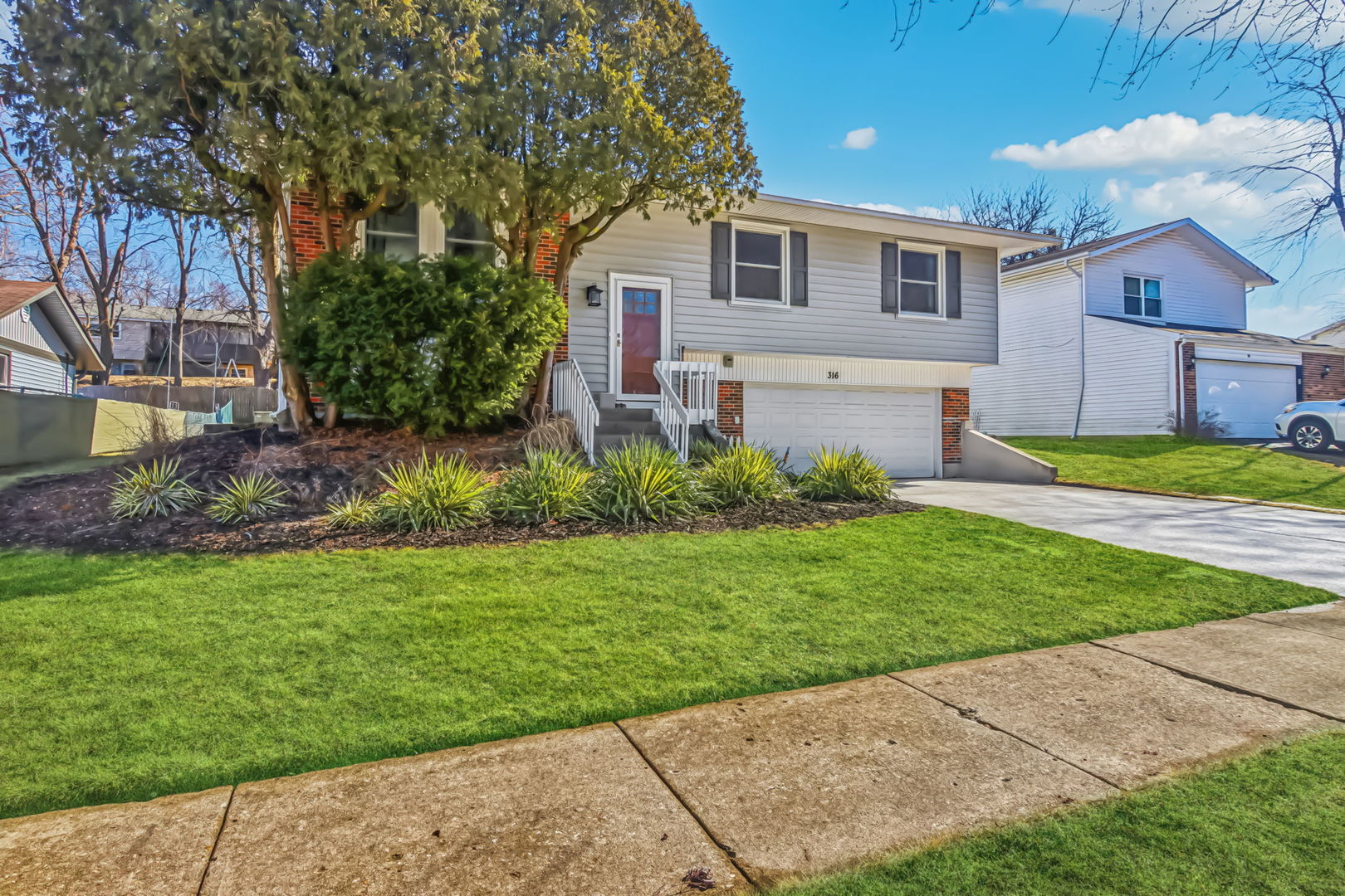 316 Bedford Road Bolingbrook, IL 60440 - Photo 2 of 38 a front view of a house with a yard and a garage