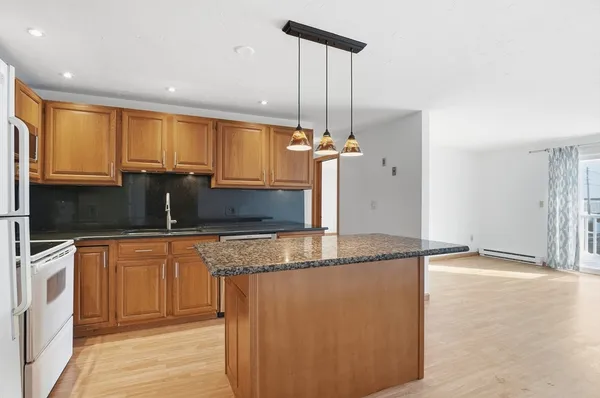a kitchen with stainless steel appliances granite countertop a sink a stove and a refrigerator