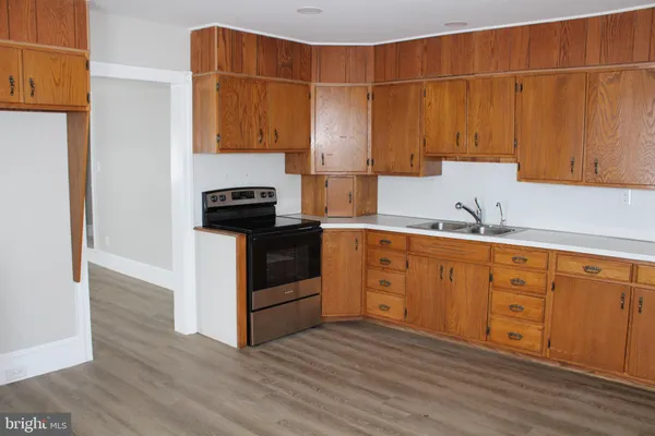 a kitchen with wooden cabinets and a stove top oven