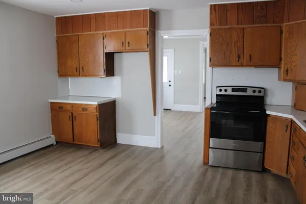 a kitchen with a wooden floor and a stove
