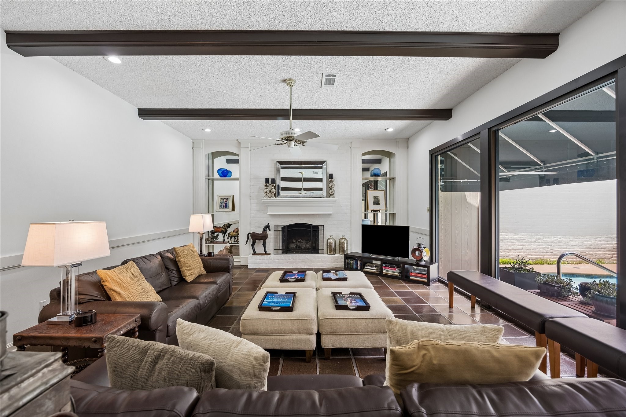 306 Gessner Road Bunker Hill Village, TX 77024 - Photo 6 of 41 Large family room with built-ins and views of the pool.