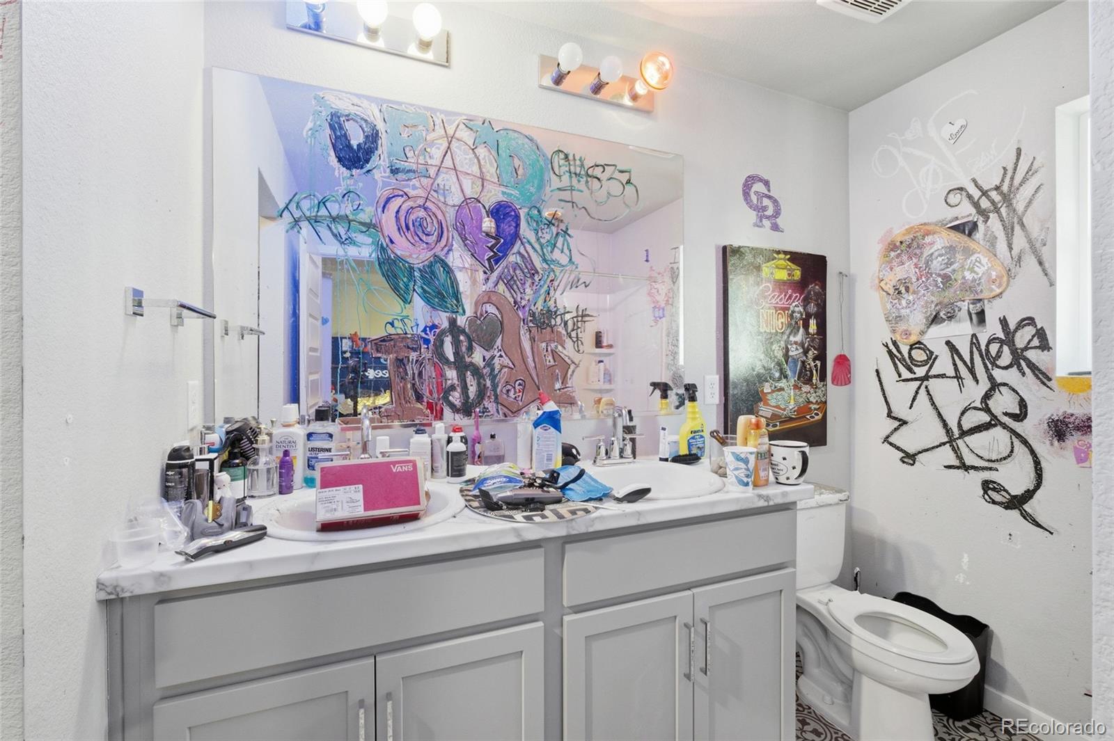 1353 Reynolds Street, Unit 11A Fort Lupton, CO 80621 - Photo 11 of 17 a bathroom with a sink mirror vanity and toilet
