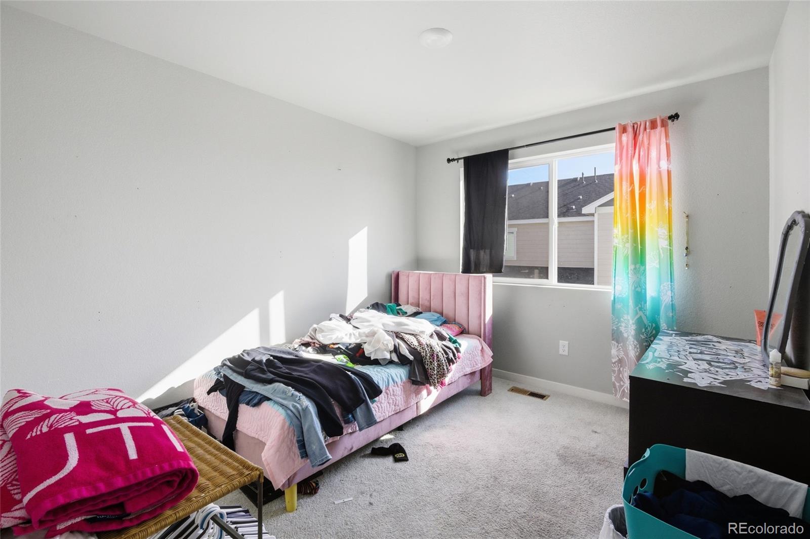 1353 Reynolds Street, Unit 11A Fort Lupton, CO 80621 - Photo 13 of 17 a bedroom with two beds and a window