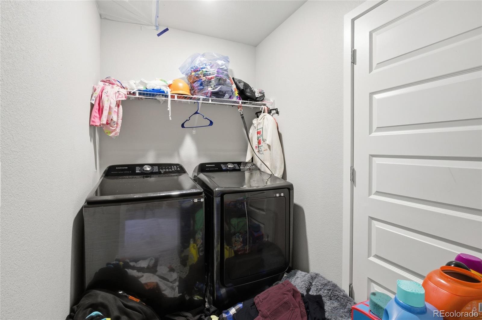 1353 Reynolds Street, Unit 11A Fort Lupton, CO 80621 - Photo 15 of 17 a storage room with washer and dryer