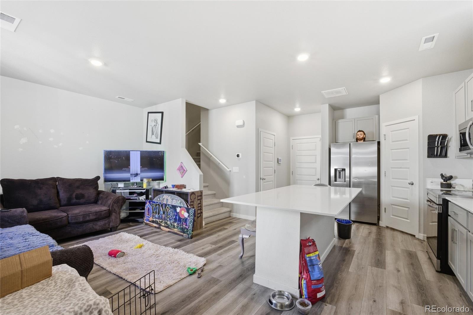 1353 Reynolds Street, Unit 11A Fort Lupton, CO 80621 - Photo 3 of 17 a living room with furniture and a wooden floor