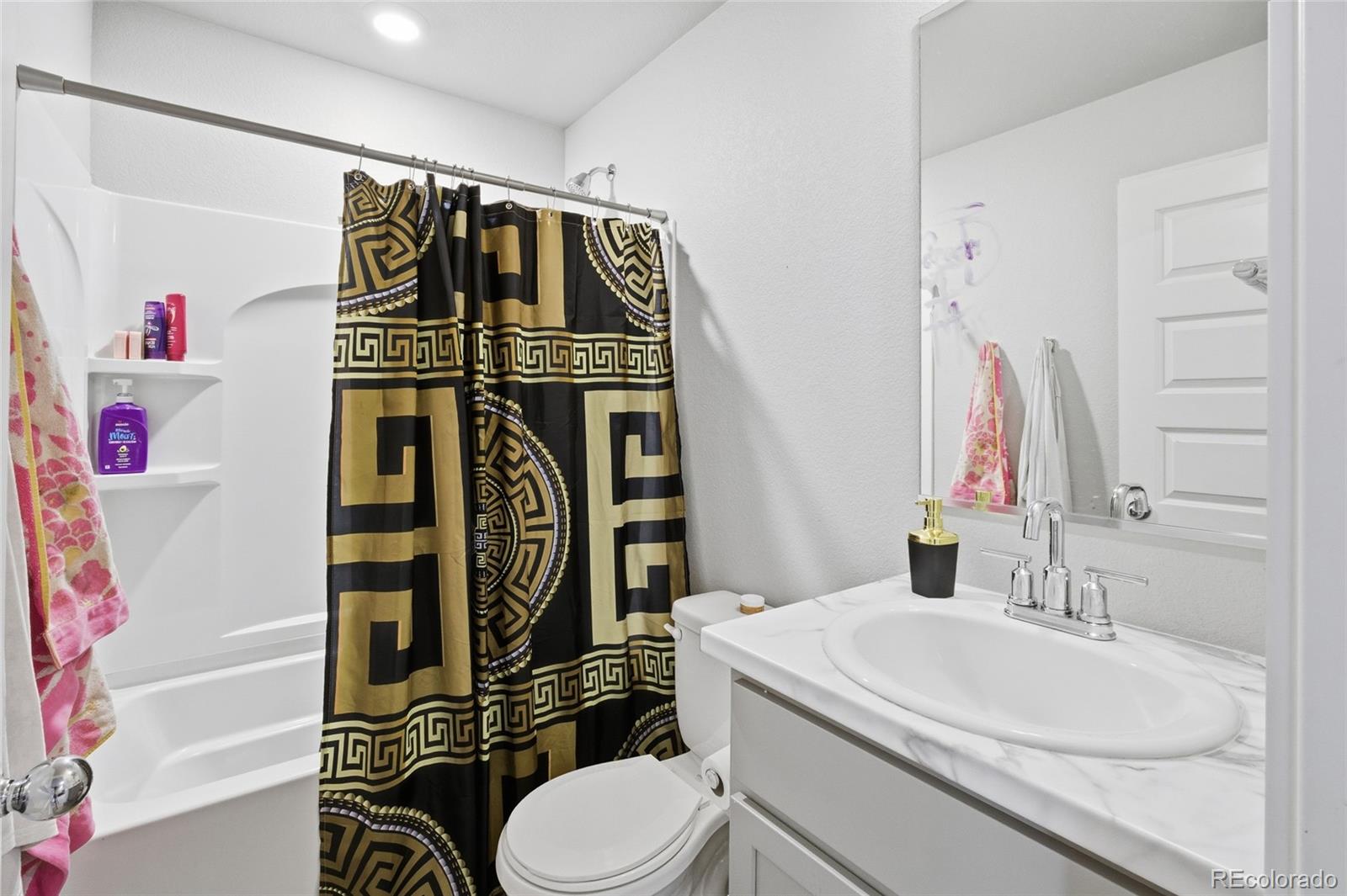 1353 Reynolds Street, Unit 11A Fort Lupton, CO 80621 - Photo 9 of 17 a bathroom with a sink toilet and shower