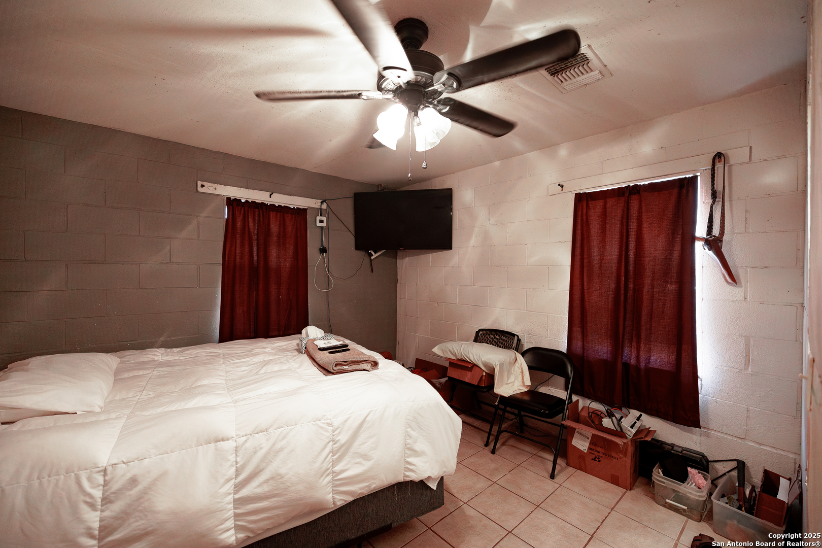 Tbd Old Pleasanton Road Poteet, TX 78264 - Photo 18 of 24 a bedroom with a bed and a chandelier