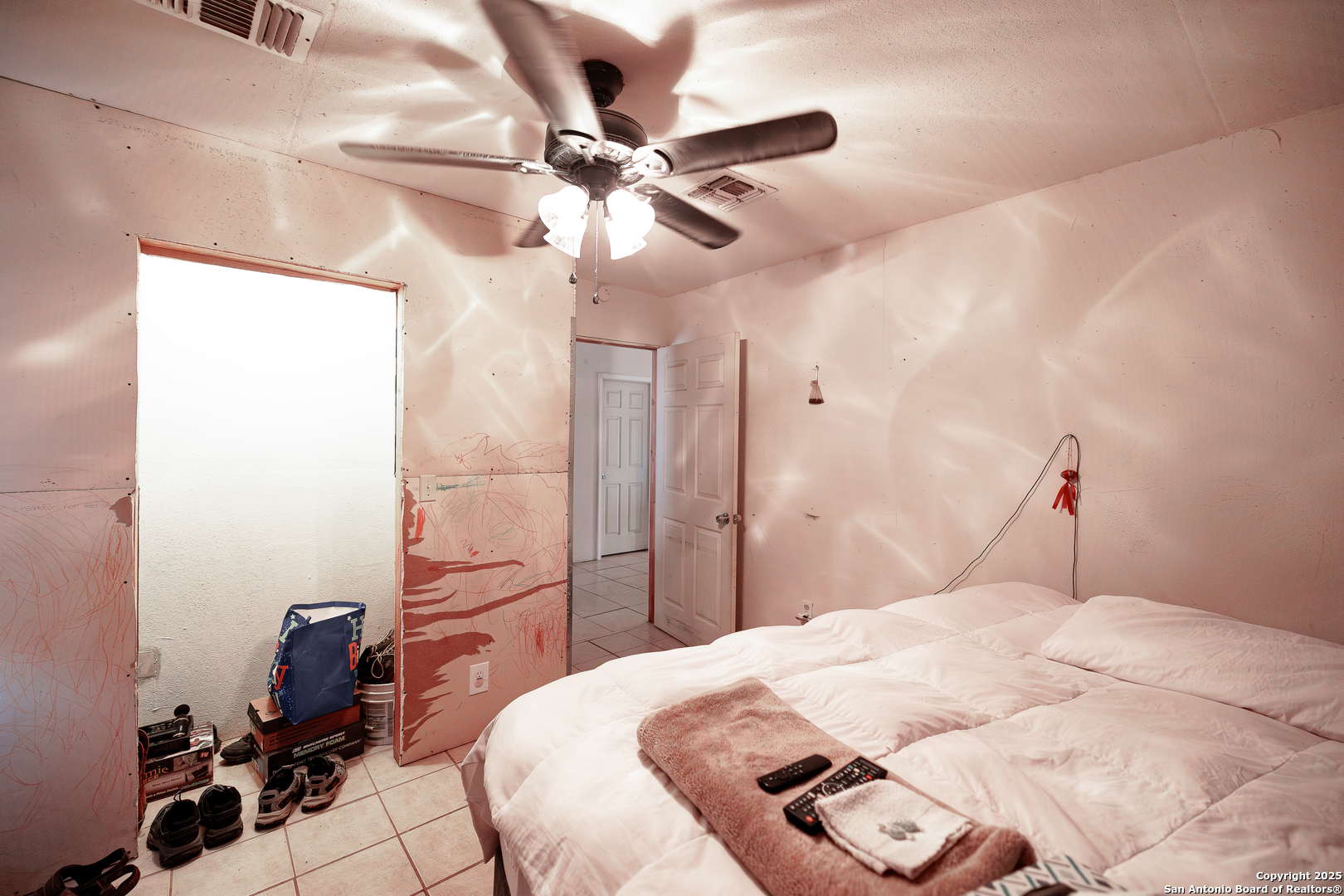 Tbd Old Pleasanton Road Poteet, TX 78264 - Photo 19 of 24 a bedroom with a bed and a chandelier