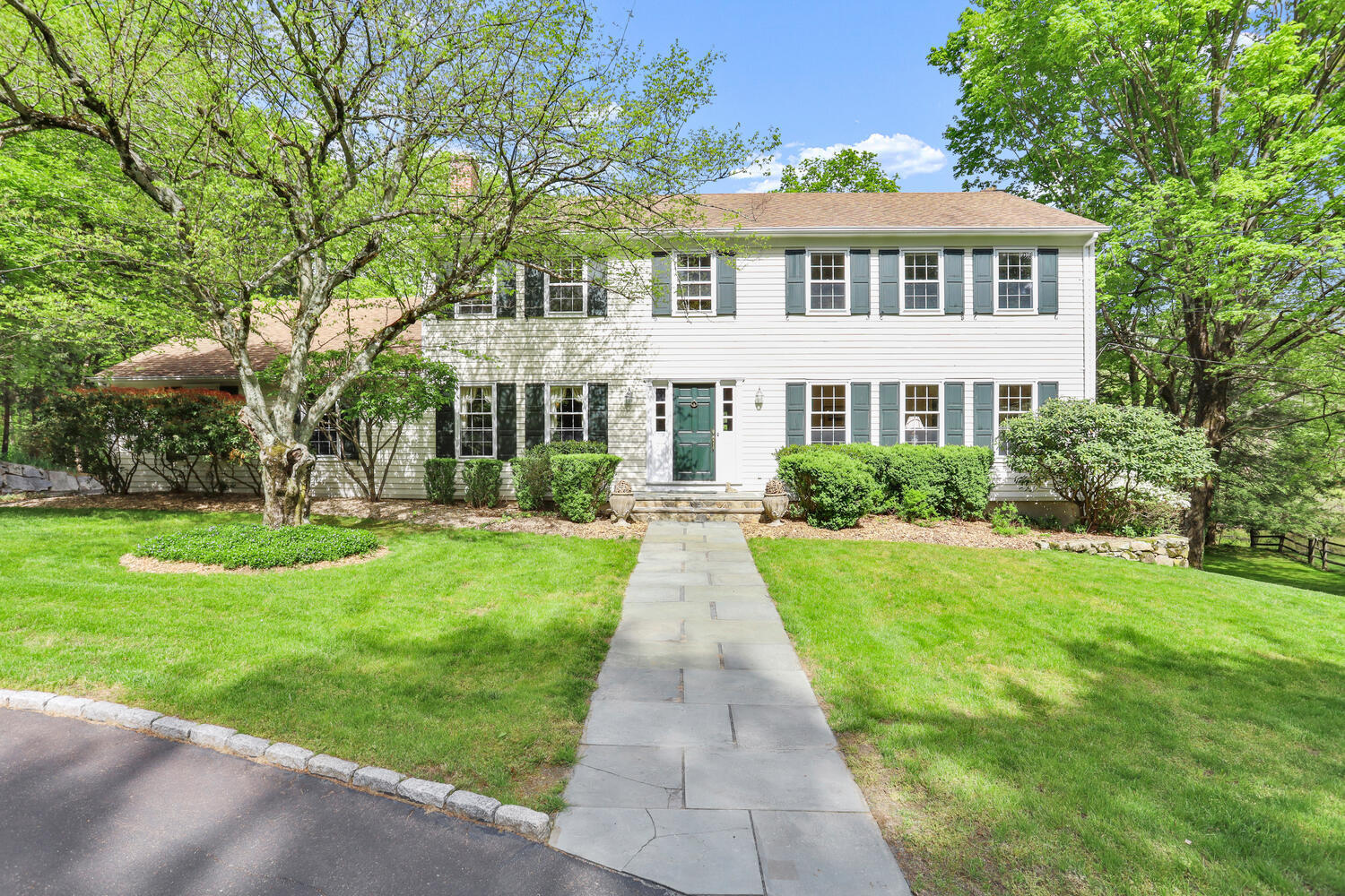 781 Valley Road New Canaan, CT 06840 - Photo 2 of 29 a front view of a house with a yard