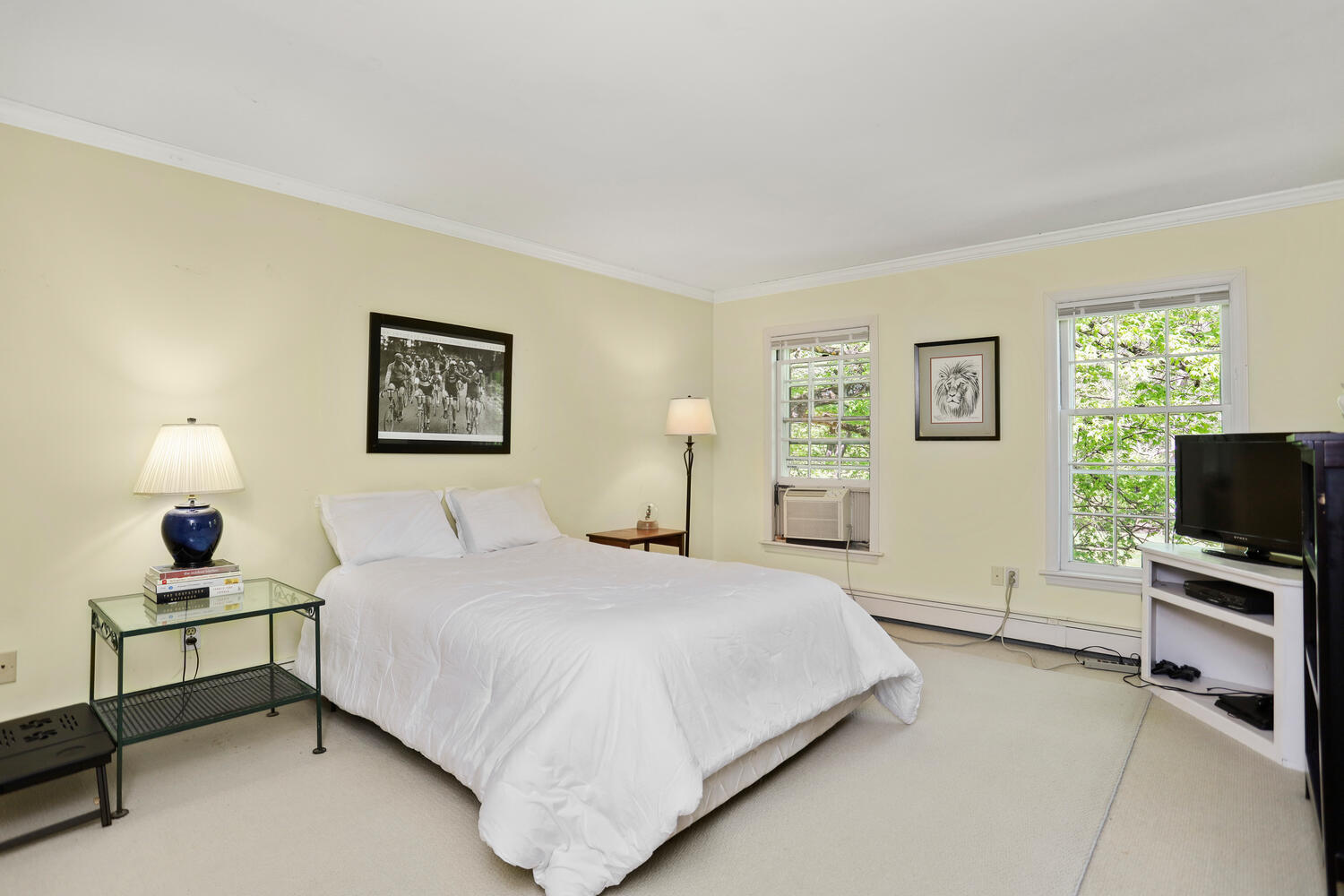 781 Valley Road New Canaan, CT 06840 - Photo 12 of 29 a bedroom with a bed and a flat tv screen on the dresser