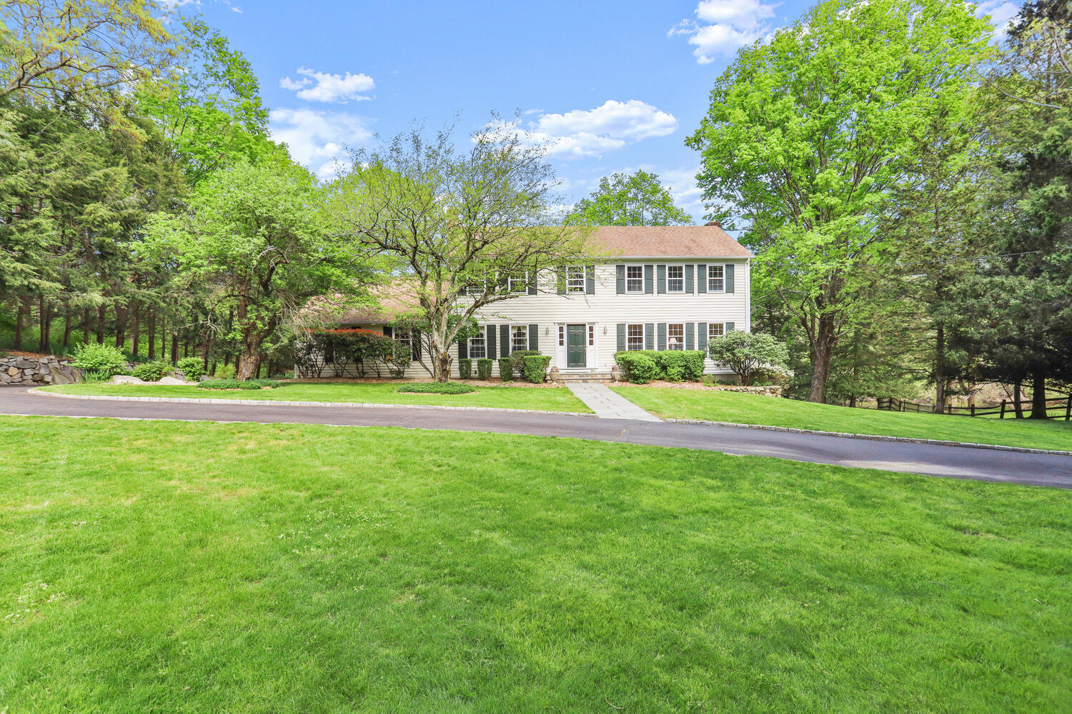 781 Valley Road New Canaan, CT 06840 - Photo 20 of 29 a view of a house with a big yard and large trees
