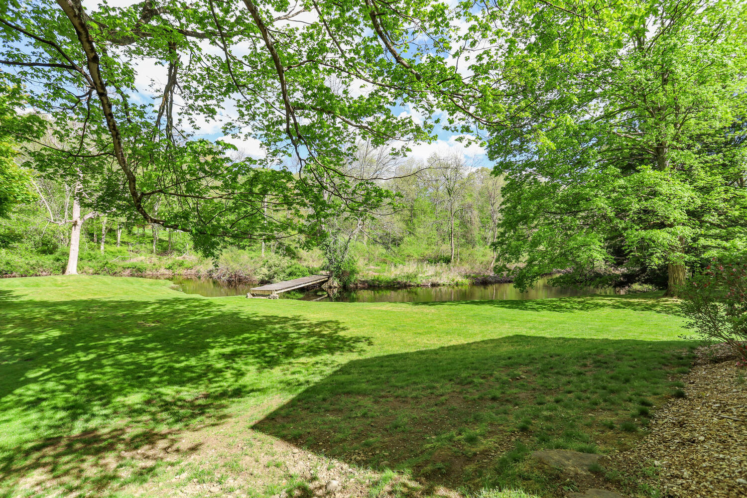 781 Valley Road New Canaan, CT 06840 - Photo 22 of 29 a view of a grassy field with trees