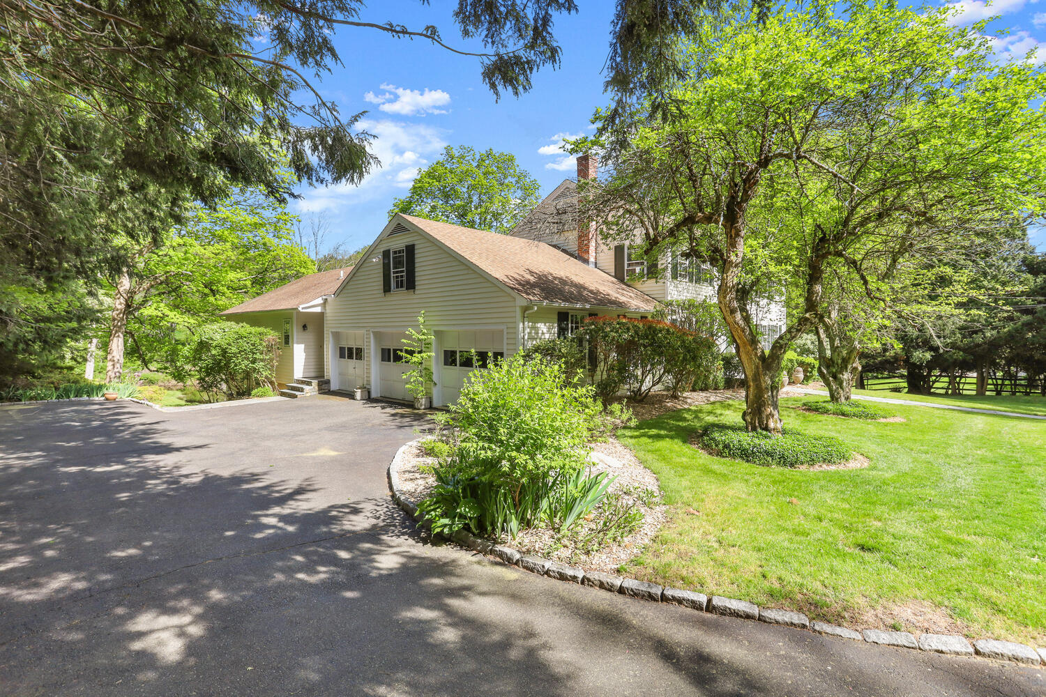 781 Valley Road New Canaan, CT 06840 - Photo 24 of 29 a front view of house with yard and green space