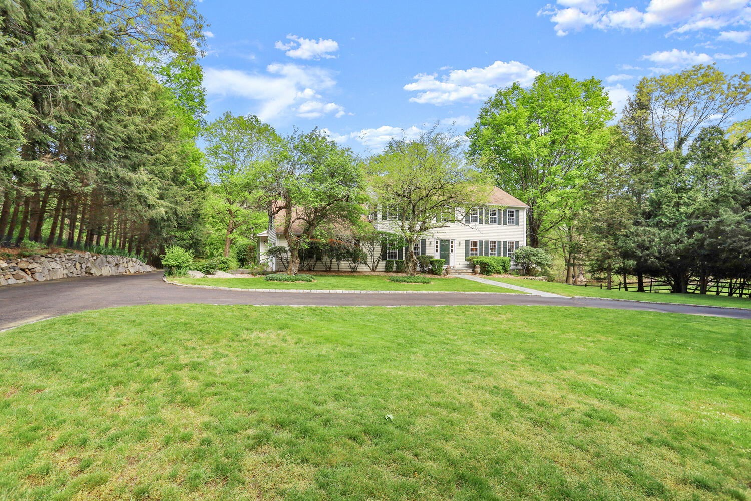 781 Valley Road New Canaan, CT 06840 - Photo 25 of 29 a front view of a house with a yard