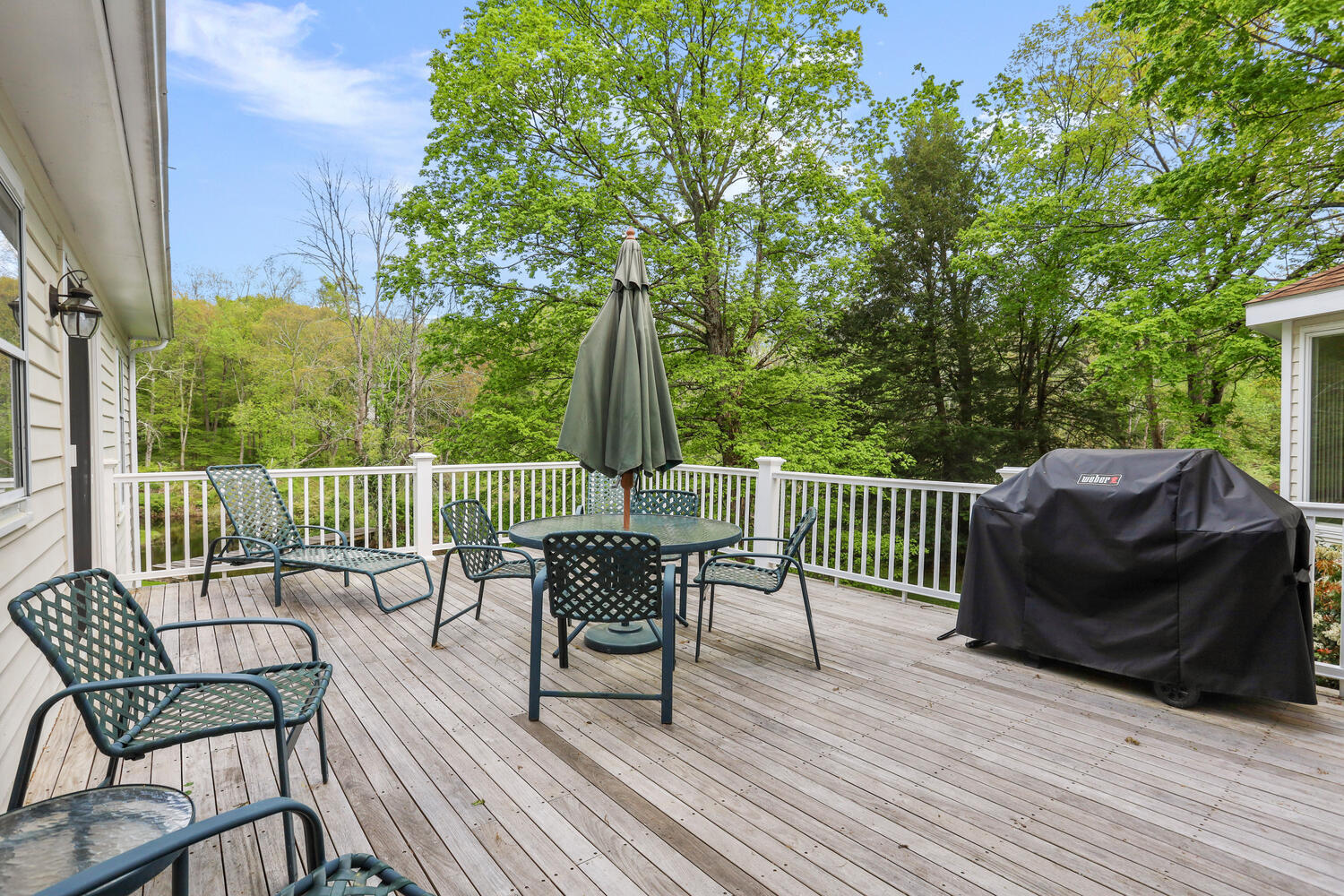 781 Valley Road New Canaan, CT 06840 - Photo 7 of 29 a view of a chair and table on the deck