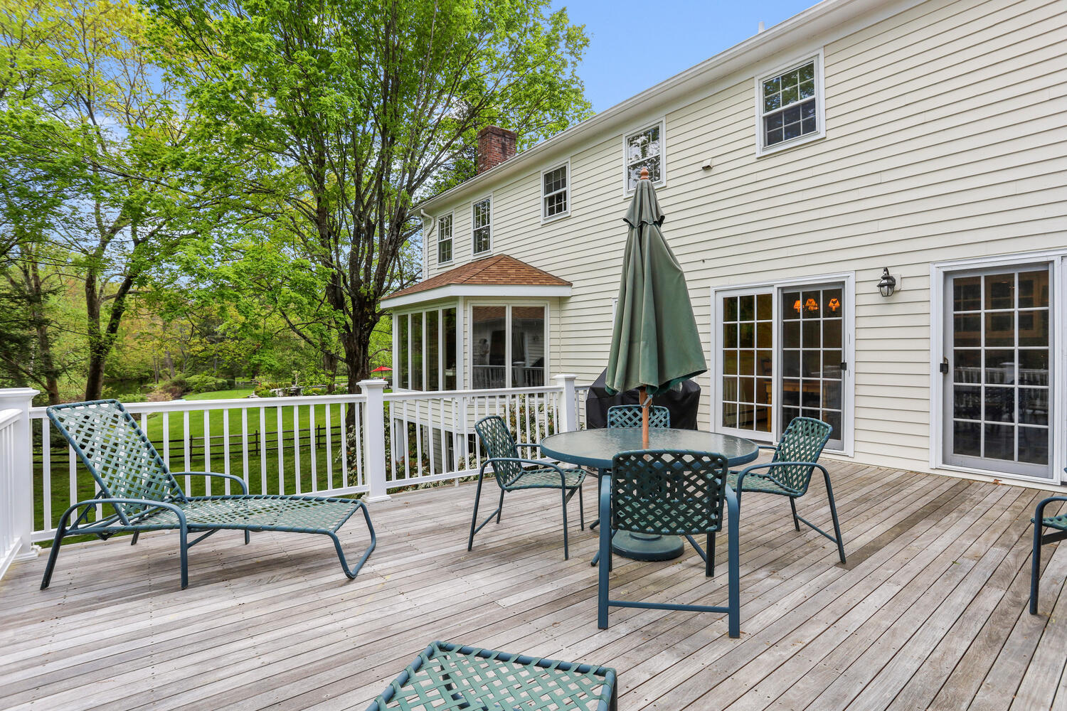 781 Valley Road New Canaan, CT 06840 - Photo 8 of 29 a view of a house with wooden deck and furniture