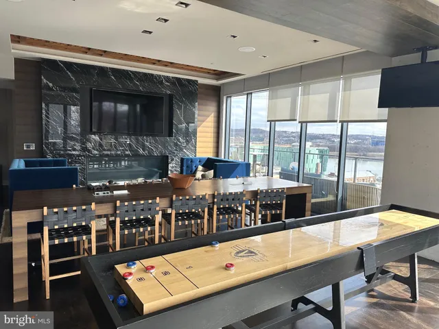 a room with furniture pool table and flat screen tv