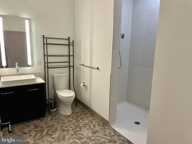 a bathroom with a toilet sink and a shower
