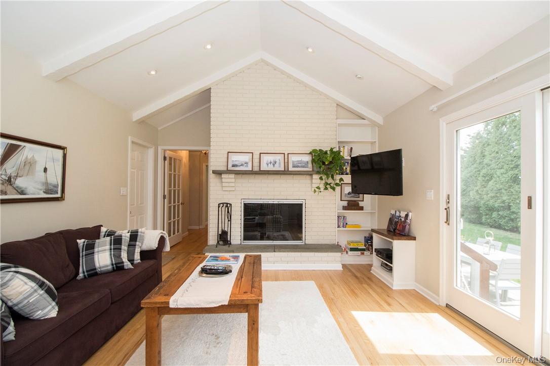 4 Dalphin Drive Rye, NY 10580 - Photo 12 of 24 Family room with vaulted ceiling and sliding doors to backyard