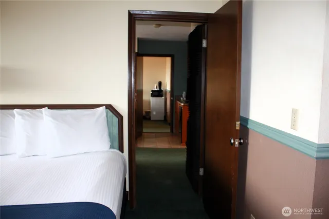 a bedroom with a bed and a lamp