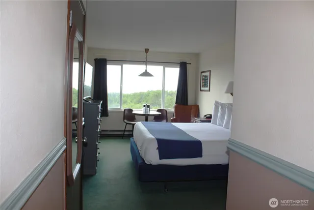 a bed room with a bed and a lamp