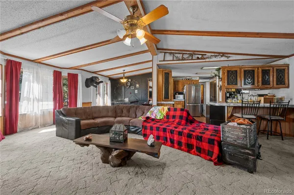a living room with lots of furniture and a chandelier