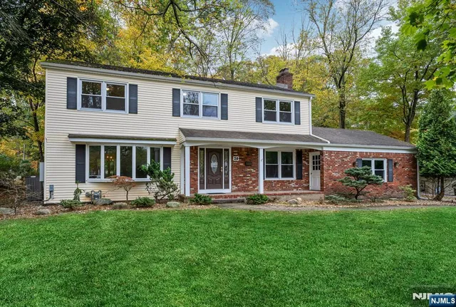 a front view of a house with a yard and sitting area