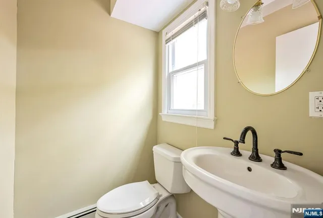 a white toilet sitting next to a bathroom sink