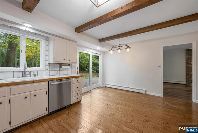 a spacious bathroom with a granite countertop sink and a mirror
